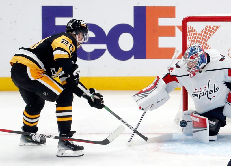 Jan 2, 2024; Pittsburgh, Pennsylvania, USA;  Washington Capitals goaltender Darcy Kuemper (35) makes a save against Pittsburgh Penguins center Lars Eller (20) during the third period at PPG Paints Arena. Mandatory Credit: Charles LeClaire-USA TODAY Sports