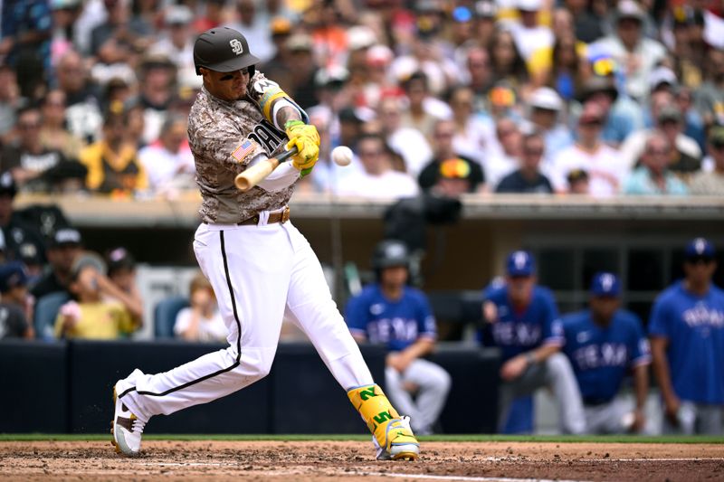 Jul 30, 2023; San Diego, California, USA; San Diego Padres third baseman Manny Machado (13) hits a single against the Texas Rangers during the third inning at Petco Park. Mandatory Credit: Orlando Ramirez-USA TODAY Sports