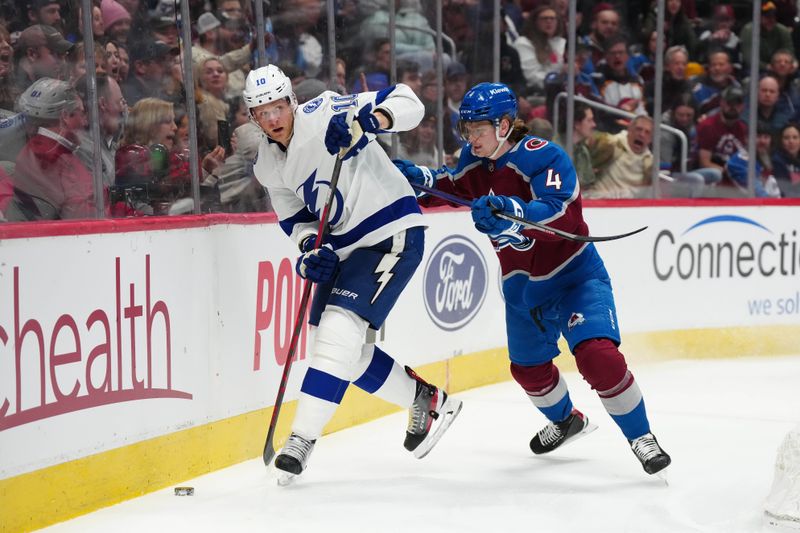 Feb 14, 2023; Denver, Colorado, USA; Tampa Bay Lightning right wing Corey Perry (10) and Colorado Avalanche defenseman Bowen Byram (4) skate to the puck in first period at Ball Arena. Mandatory Credit: Ron Chenoy-USA TODAY Sports