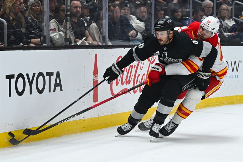Feb 28, 2026; Los Angeles, California, USA; Los Angeles Kings defenseman Joel Edmundson (6) and Calgary Flames right wing Adam Klapka (43) battle for the puck during the first period at Crypto.com Arena. Mandatory Credit: Griffin Hooper-Imagn Images