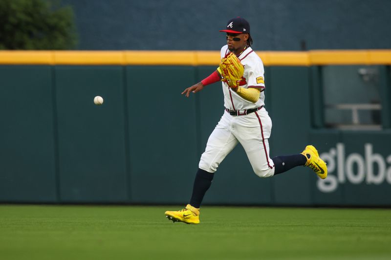 Apr 6, 2024; Atlanta, Georgia, USA; Atlanta Braves right fielder Ronald Acuna Jr. (13) fields a ball against the Arizona Diamondbacks in the first inning at Truist Park. Mandatory Credit: Brett Davis-USA TODAY Sports