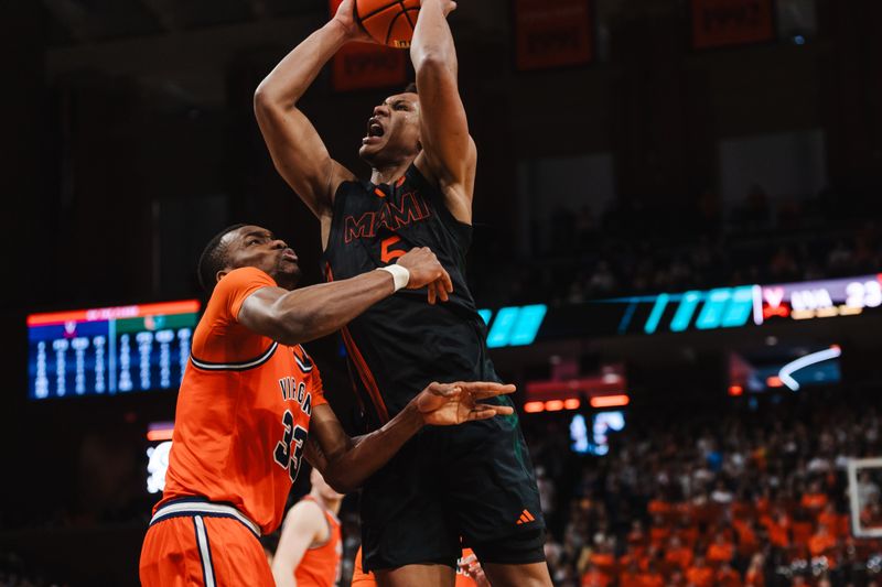 Feb 21, 2026; Charlottesville, Virginia, USA; Miami (FL) Hurricanes forward Malik Reneau (5) shoots the ball while Virginia Cavaliers center Ugonna Onyenso (33) defends during the first half at John Paul Jones Arena. Mandatory Credit: Emily Faith Morgan-Imagn Images