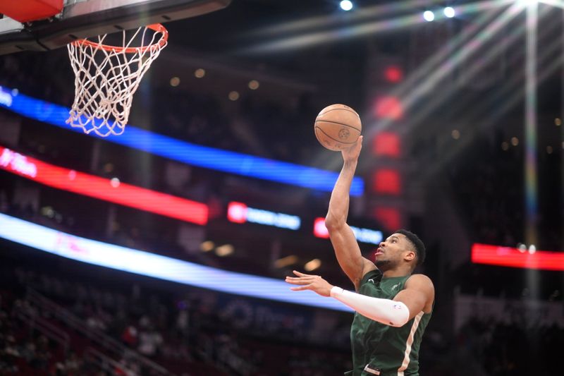 HOUSTON, TX - JANUARY 6: (EDITOR'S NOTE: Image was taken with a star filter) Giannis Antetokounmpo #34 of the Milwaukee Bucks shoots the ball before the game against the Houston Rockets on January 6, 2024 at the Toyota Center in Houston, Texas. NOTE TO USER: User expressly acknowledges and agrees that, by downloading and or using this photograph, User is consenting to the terms and conditions of the Getty Images License Agreement. Mandatory Copyright Notice: Copyright 2024 NBAE (Photo by Logan Riely/NBAE via Getty Images)