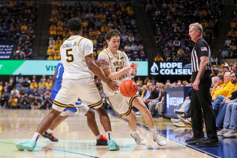 Feb 28, 2026; Morgantown, West Virginia, USA; West Virginia Mountaineers forward DJ Thomas (5) hands the ball off to West Virginia Mountaineers guard Treysen Eaglestaff (52) during the second half against the BYU Cougars at Hope Coliseum. Mandatory Credit: Ben Queen-Imagn Images