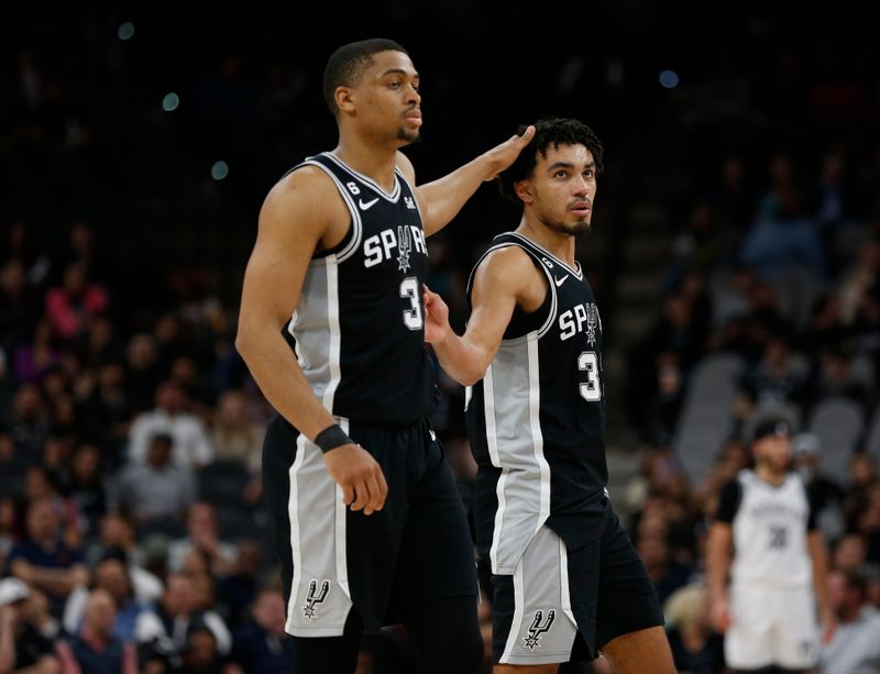 SAN ANTONIO, TX - JANUARY 17: Tre Jones #33 of the San Antonio Spurs is congratulated by  Keldon Johnson #3 after they took a lead against the Brooklyn Nets in the second half at AT&T Center on January 17, 2023 in San Antonio, Texas. NOTE TO USER: User expressly acknowledges and agrees that, by downloading and or using this photograph, User is consenting to terms and conditions of the Getty Images License Agreement. (Photo by Ronald Cortes/Getty Images)