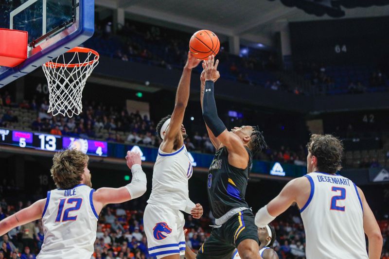 Feb 20, 2024; Boise, Idaho, USA;  Boise State Broncos guard Chibuzo Agbo (11) blocks the shot of San Jose State Spartans guard Myron Amey Jr. (0) during the first half  at ExtraMile Arena. Mandatory Credit: Brian Losness-USA TODAY Sports


