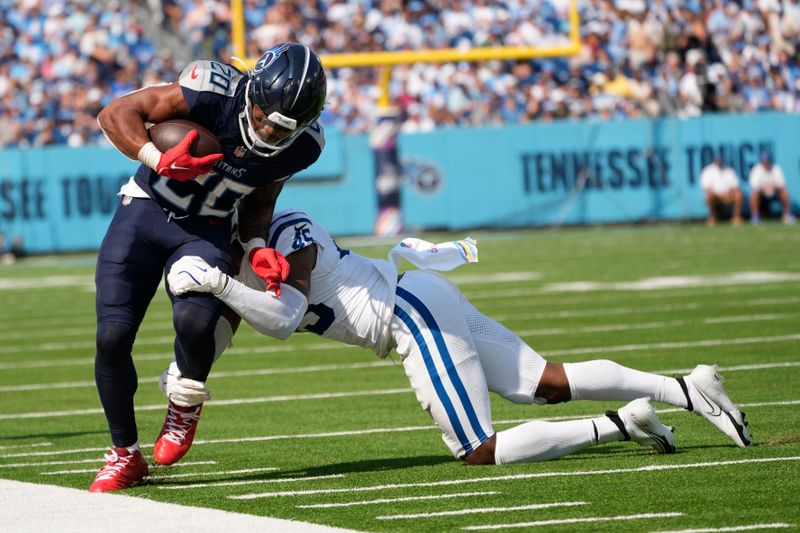 Tennessee Titans running back Tony Pollard (20) is tackled by Indianapolis Colts' E.J. Speed (45) during the second half of an NFL football game, Sunday, Oct. 13, 2024, in Nashville, Tenn. (AP Photo/George Walker IV)