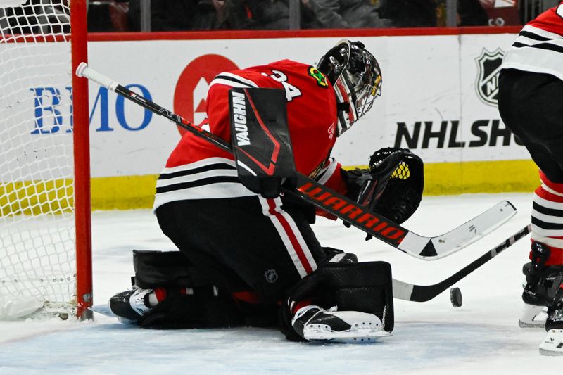 Jan 20, 2025; Chicago, Illinois, USA;  Chicago Blackhawks goaltender Petr Mrazek (34) defends against the Carolina Hurricanes during the first period at the United Center. Mandatory Credit: Matt Marton-Imagn Images


