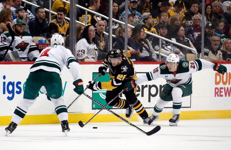 Apr 6, 2023; Pittsburgh, Pennsylvania, USA; Pittsburgh Penguins center Ryan Poehling (25) skates up ice with the puck against Minnesota Wild defenseman Jon Merrill (4) and center Connor Dewar (26) during the second period at PPG Paints Arena. Pittsburgh won 4-1.Mandatory Credit: Charles LeClaire-USA TODAY Sports