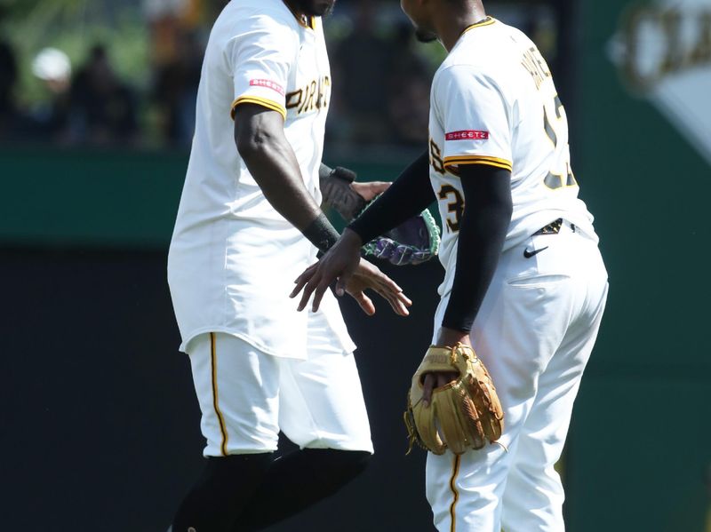 Jun 29, 2025; Pittsburgh, Pennsylvania, USA;  Pittsburgh Pirates center fielder Oneil Cruz (left) and third baseman Ke'Bryan Hayes (13) celebrate after defeating the New York Mets at PNC Park. Mandatory Credit: Charles LeClaire-Imagn Images