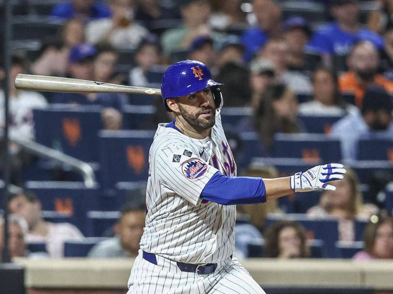 Aug 14, 2024; New York City, New York, USA;  New York Mets designated hitter J.D. Martinez (28) hits an RBI double in the seventh inning against the Oakland Athletics at Citi Field. Mandatory Credit: Wendell Cruz-USA TODAY Sports