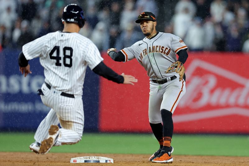 Apr 1, 2023; Bronx, New York, USA; San Francisco Giants second baseman Thairo Estrada (39) forces out New York Yankees first baseman Anthony Rizzo (48) at second then throws to first to complete the game ending double play on a ball hit by Yankees right fielder Giancarlo Stanton (27) during the ninth inning at Yankee Stadium. Mandatory Credit: Brad Penner-USA TODAY Sports