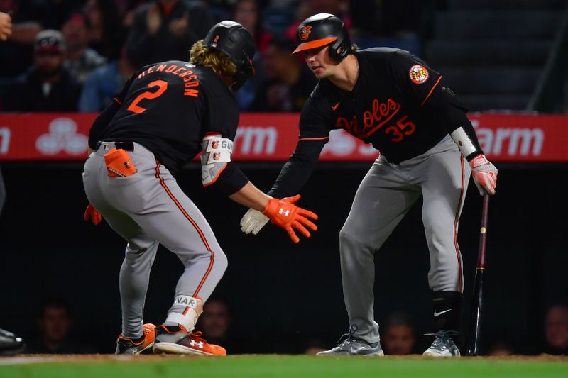 Apr 23, 2024; Anaheim, California, USA; Baltimore Orioles shortstop Gunnar Henderson (2) is greeted by catcher Adley Rutschman (35) after hitting a solo home run against the Los Angeles Angels during the seventh inning at Angel Stadium. Mandatory Credit: Gary A. Vasquez-USA TODAY Sports