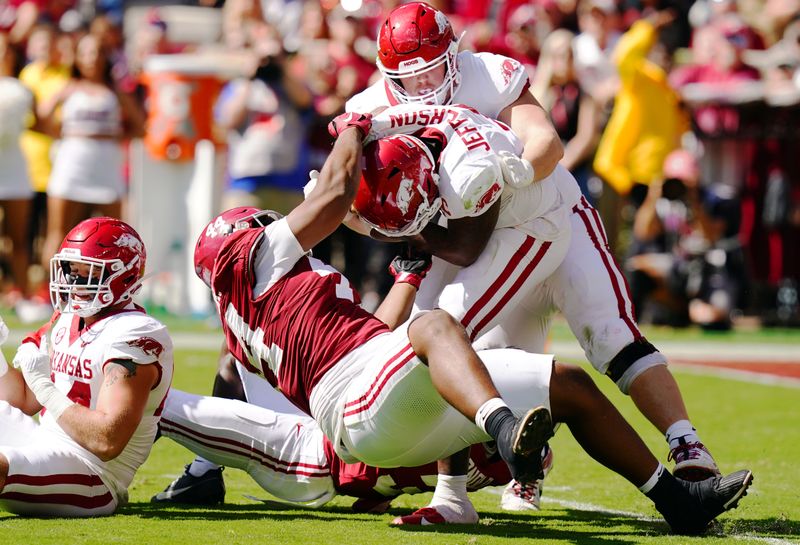 Oct 14, 2023; Tuscaloosa, Alabama, USA; Arkansas Razorbacks quarterback KJ Jefferson (1) gets wrapped up by Alabama Crimson Tide defensive back Terrion Arnold (3) and defensive lineman Damon Payne Jr. (44) during the second half at Bryant-Denny Stadium. Mandatory Credit: John David Mercer-USA TODAY Sports