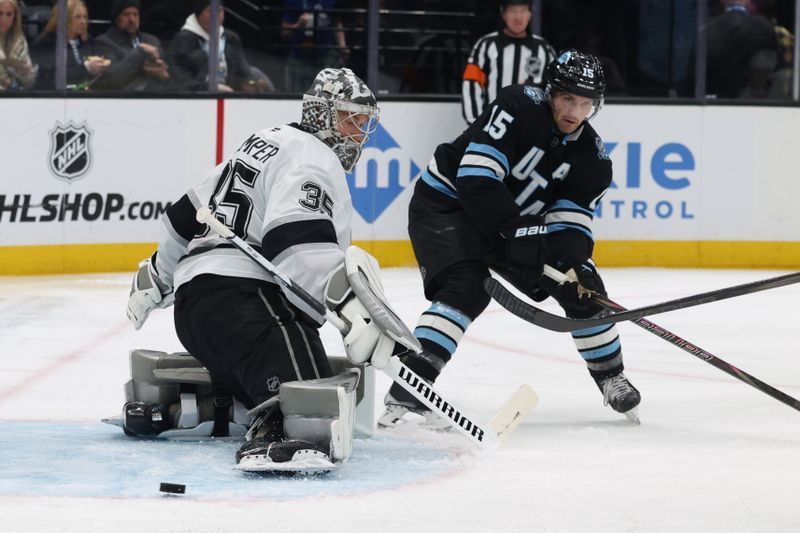 Apr 3, 2025; Salt Lake City, Utah, USA; Los Angeles Kings goaltender Darcy Kuemper (35) makes a save against Utah Hockey Club center Alexander Kerfoot (15) during the second period at Delta Center. Mandatory Credit: Rob Gray-Imagn Images