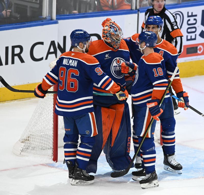 Mar 22, 2025; Edmonton, Alberta, CAN;  Edmonton Oilers defenceman Jake Walman (96) celebrates their win with  Oilers goalie Stuart Skinner (74) and Oilers left winger Zach Hyman (18) during the third period at Rogers Place. Mandatory Credit: Walter Tychnowicz-Imagn Images