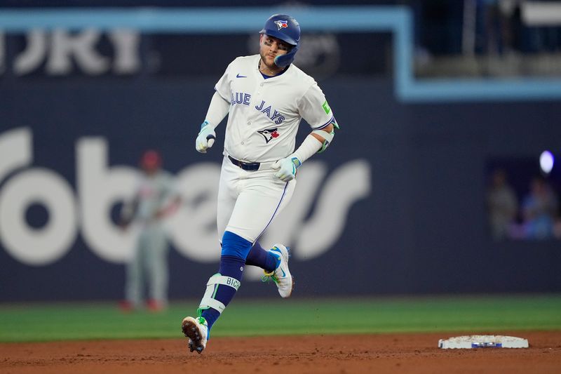 Jun 5, 2025; Toronto, Ontario, CAN; Toronto Blue Jays shortstop Bo Bichette (11) rounds the base on his two run home run against the Philadelphia Phillies during the second inning at Rogers Centre. Mandatory Credit: John E. Sokolowski-Imagn Images