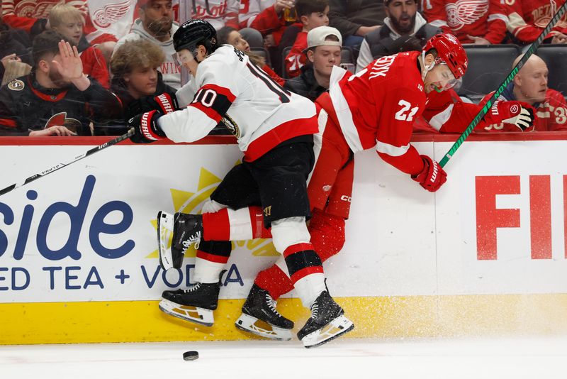 Mar 24, 2026; Detroit, Michigan, USA;  Ottawa Senators defenseman Jordan Spence (10) checks Detroit Red Wings left wing James van Riemsdyk (21) in the second period at Little Caesars Arena. Mandatory Credit: Rick Osentoski-Imagn Images