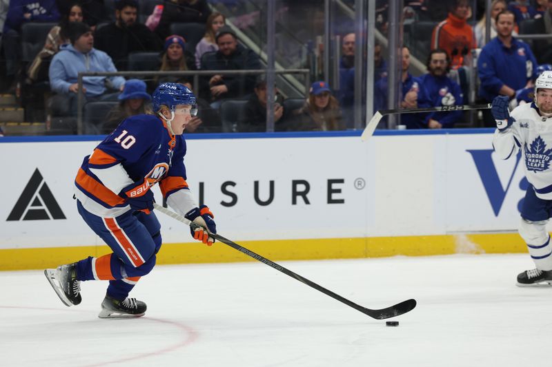 Jan 3, 2026; Elmont, New York, USA; New York Islanders right wing Simon Holmstrom (10) skates with the puck against the Toronto Maple Leafs during the first period at UBS Arena. Mandatory Credit: Thomas Salus-Imagn Images