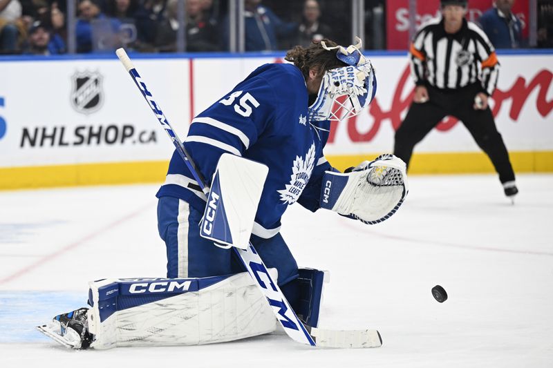Nov 8, 2025; Toronto, Ontario, CAN;  Toronto Maple Leafs goalie Dennis Hildeby (35) loses his mask after stopping a shot with it against the Boston Bruins in the second period at Scotiabank Arena. Mandatory Credit: Dan Hamilton-Imagn Images