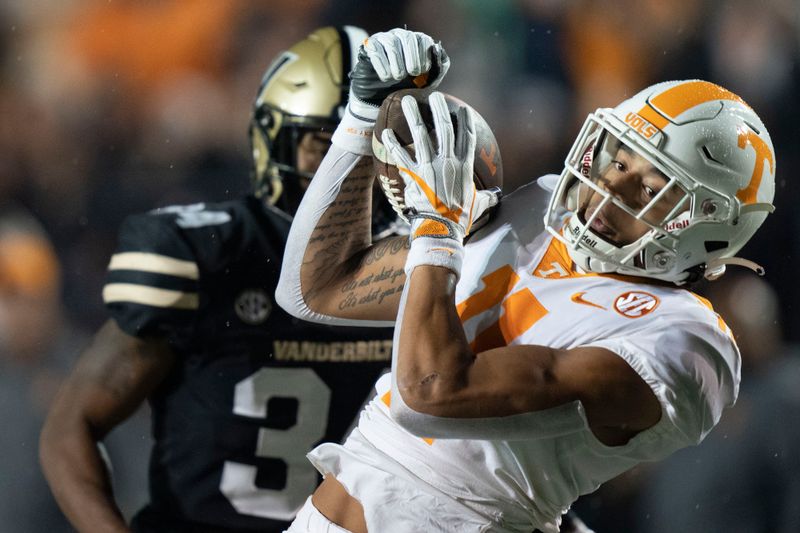 Nov 26, 2022; Nashville, Tennessee, USA;   
Tennessee Volunteers wide receiver Jalin Hyatt (11) pulls in a first down catch against Vanderbilt Commodores defensive back Ja'Dais Richard (34) during the first quarter at FirstBank Stadium. Mandatory Credit: George Walker IV - USA TODAY Sports