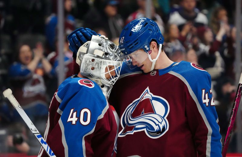 Feb 20, 2024; Denver, Colorado, USA; Colorado Avalanche goaltender Alexandar Georgiev (40) and Colorado Avalanche defenseman Josh Manson (42) celebrate defeating the Vancouver Canucks at Ball Arena. Mandatory Credit: Ron Chenoy-USA TODAY Sports