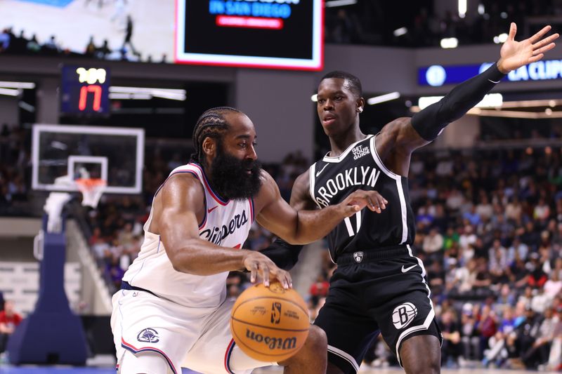 OCEANSIDE, CALIFORNIA - OCTOBER 08:    James Harden #1 of the Los Angeles Clippers drives against Dennis Schroder #17 of the Brooklyn Nets in the first quarter of the preseason game at Frontwave Arena on October 08, 2024 in Oceanside, California. NOTE TO USER: User expressly acknowledges and agrees that, by downloading and or using this photograph, User is consenting to the terms and conditions of the Getty Images License Agreement. (Photo by Joe Scarnici/Getty Images)