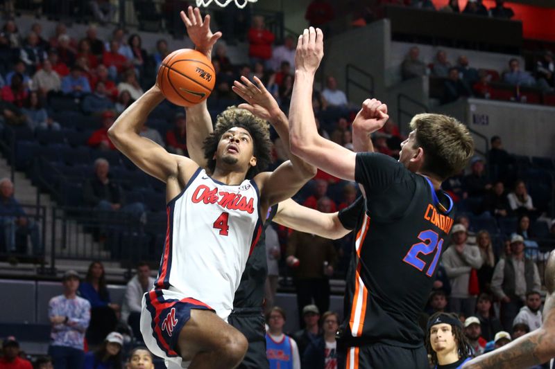 Jan 10, 2024; Oxford, Mississippi, USA; Mississippi Rebels forward Jaemyn Brakefield (4) drives to the basket as Florida Gators forward/center Alex Condon (21) defends during the second half at The Sandy and John Black Pavilion at Ole Miss. Mandatory Credit: Petre Thomas-USA TODAY Sports