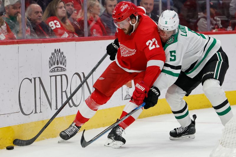 Jan 23, 2024; Detroit, Michigan, USA;  Detroit Red Wings center Michael Rasmussen (27) skates with the puck defended by Dallas Stars defenseman Nils Lundkvist (5) in the second period at Little Caesars Arena. Mandatory Credit: Rick Osentoski-USA TODAY Sports