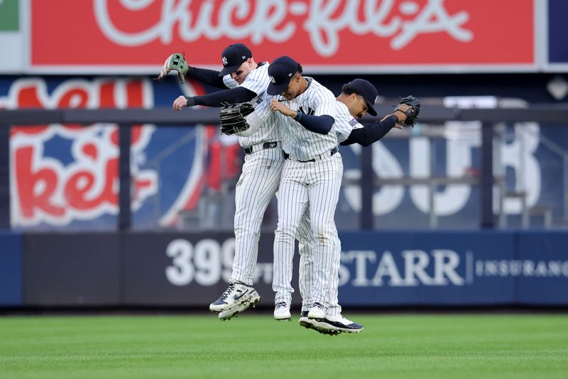 Aug 7, 2024; Bronx, New York, USA; New York Yankees left fielder Alex Verdugo (24) and right fielder Juan Soto (22) and center fielder Trent Grisham (12) celebrate after defeating the Los Angeles Angels at Yankee Stadium. Mandatory Credit: Brad Penner-USA TODAY Sports