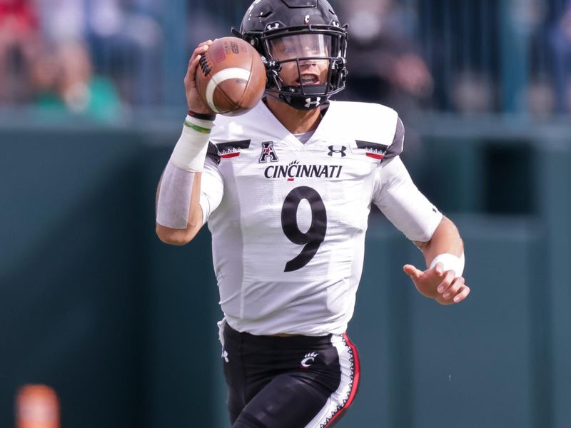 Oct 30, 2021; New Orleans, Louisiana, USA;  Cincinnati Bearcats quarterback Desmond Ridder (9) scrambles out the pocket against Tulane Green Wave during the first half at Yulman Stadium. Mandatory Credit: Stephen Lew-USA TODAY Sports