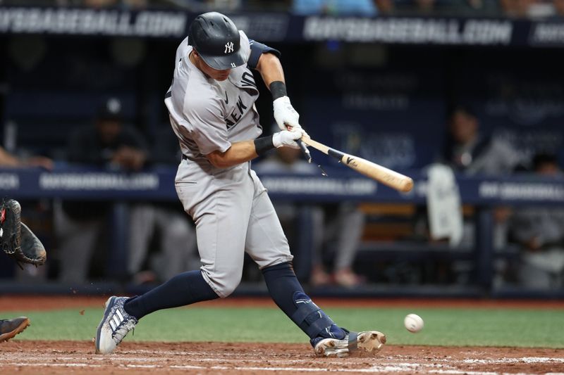 Jul 10, 2024; St. Petersburg, Florida, USA; New York Yankees shortstop Anthony Volpe (11) breaks his bat on a ground ball against the Tampa Bay Rays in the sixth inning  at Tropicana Field. Mandatory Credit: Nathan Ray Seebeck-USA TODAY Sports