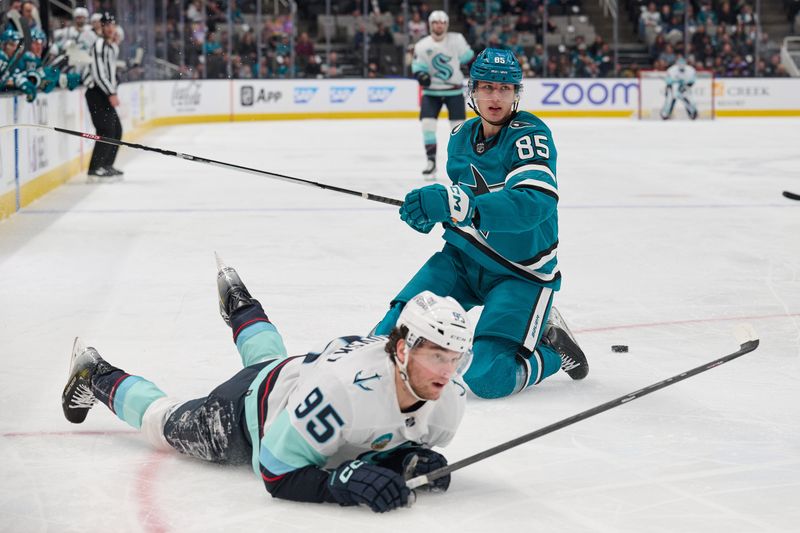 Jan 30, 2024; San Jose, California, USA; San Jose Sharks defenseman Shakir Mukhamadullin (85) and Seattle Kraken left wing Andre Burakovsky (95) after a penalty is called against Mukhamadullin during the first period at SAP Center at San Jose. Mandatory Credit: Robert Edwards-USA TODAY Sports