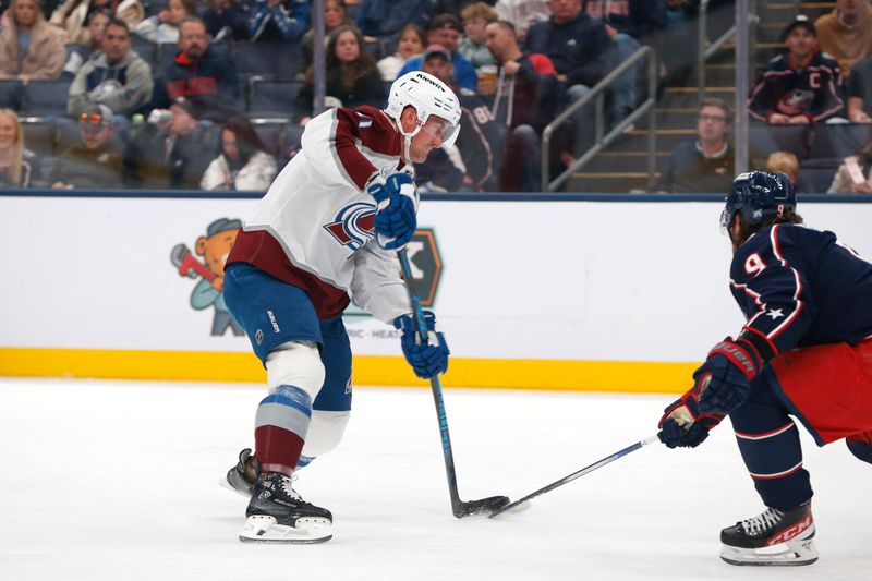 Oct 16, 2025; Columbus, Ohio, USA; Columbus Blue Jackets defenseman Ivan Provorov (9) blocks the shot attempt of Colorado Avalanche center Brock Nelson (11) during the first period at Nationwide Arena. Mandatory Credit: Russell LaBounty-Imagn Images