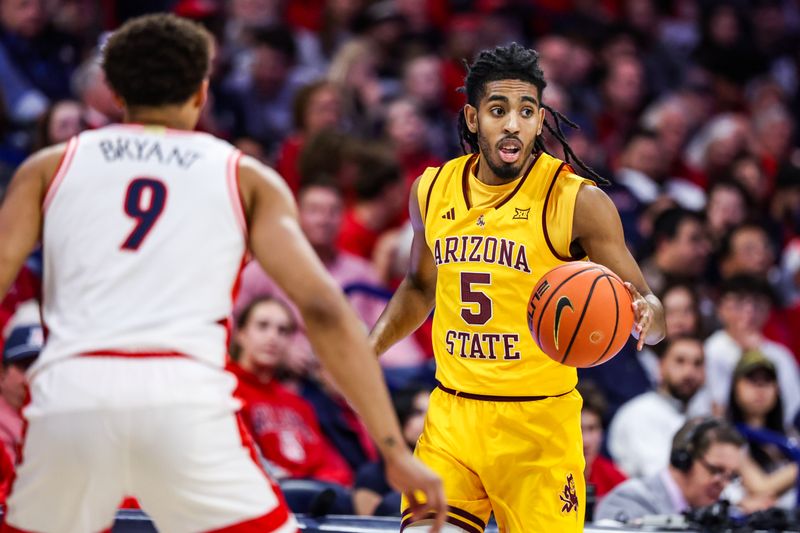 Mar 4, 2025; Tucson, Arizona, USA; Arizona State Sun Devils guard-forward Amir Ali (5) dribbles the ball against Arizona Wildcats forward Carter Bryant (9) during the first half at McKale Center. Mandatory Credit: Aryanna Frank-Imagn Images