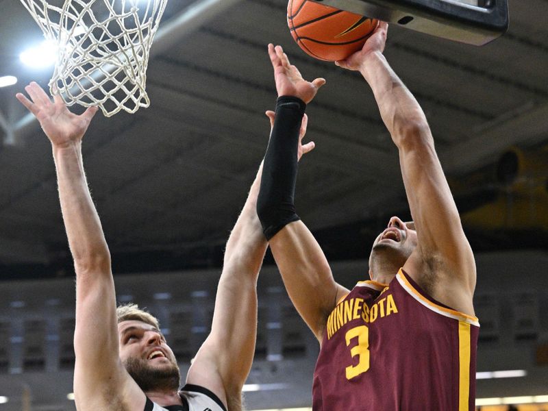 Feb 11, 2024; Iowa City, Iowa, USA; Minnesota Golden Gophers forward Dawson Garcia (3) goes to the basket as Iowa Hawkeyes forward Ben Krikke (23) defends during the first half at Carver-Hawkeye Arena. Mandatory Credit: Jeffrey Becker-USA TODAY Sports