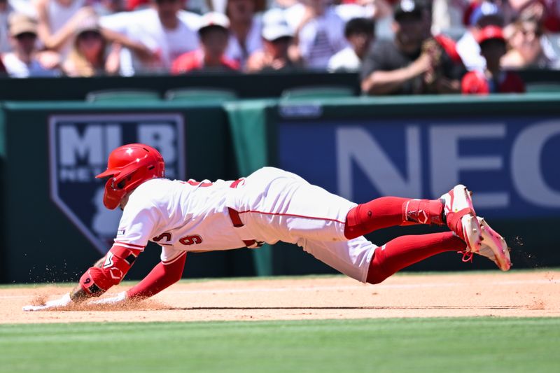 Aug 4, 2024; Anaheim, California, USA; Los Angeles Angels shortstop Zach Neto (9) slides into third base against the New York Mets during the third inning at Angel Stadium. Mandatory Credit: Jonathan Hui-USA TODAY Sports