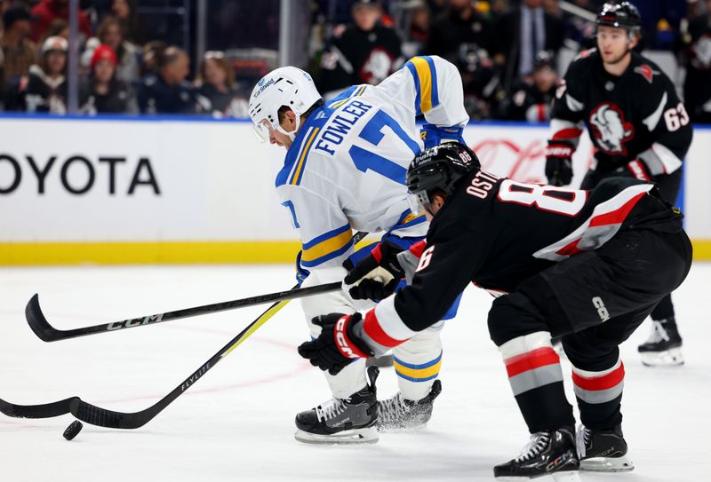Nov 6, 2025; Buffalo, New York, USA;  St. Louis Blues defenseman Cam Fowler (17) makes a pass as Buffalo Sabres center Noah Ostlund (86) defends during the first period at KeyBank Center. Mandatory Credit: Timothy T. Ludwig-Imagn Images