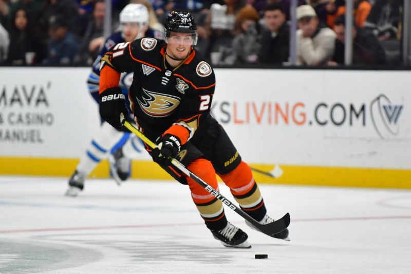 Jan 5, 2024; Anaheim, California, USA; Anaheim Ducks center Isac Lundestrom (21) moves the puck against the Winnipeg Jets during the second period at Honda Center. Mandatory Credit: Gary A. Vasquez-USA TODAY Sports