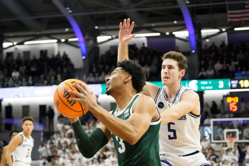 Jan 7, 2024; Evanston, Illinois, USA; Northwestern Wildcats guard Ryan Langborg (5) defends Michigan State Spartans guard Jaden Akins (3) during the first half at Welsh-Ryan Arena. Mandatory Credit: David Banks-USA TODAY Sports