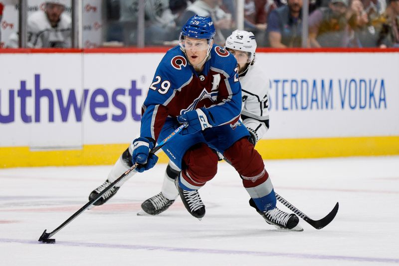 Jan 26, 2024; Denver, Colorado, USA; Colorado Avalanche center Nathan MacKinnon (29) controls the puck ahead of Los Angeles Kings center Phillip Danault (24) in the second period at Ball Arena. Mandatory Credit: Isaiah J. Downing-USA TODAY Sports