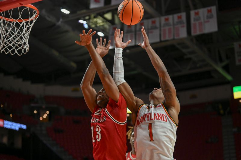 Dec 19, 2023; College Park, Maryland, USA;  Nicholls State Colonels guard Byron Ireland (13) and Maryland Terrapins guard Jahmir Young (1) leap for a loose ball during the second half at Xfinity Center. Mandatory Credit: Tommy Gilligan-USA TODAY Sports