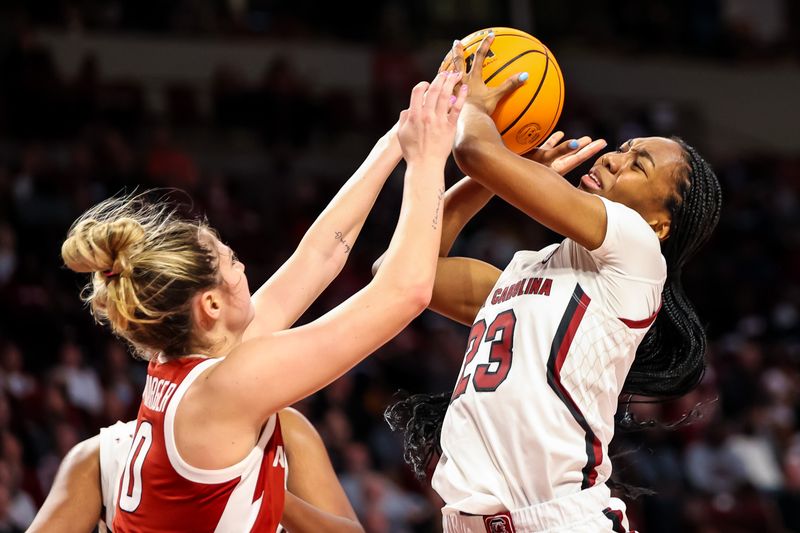 Jan 22, 2023; Columbia, South Carolina, USA; Arkansas Razorbacks guard Saylor Poffenbarger (0) ties up South Carolina Gamecocks guard Bree Hall (23) for a jump ball in the first half at Colonial Life Arena. Mandatory Credit: Jeff Blake-USA TODAY Sports