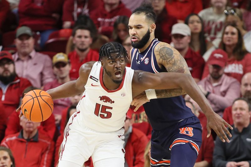 Jan 6, 2024; Fayetteville, Arkansas, USA; Arkansas Razorbacks forward Makhi Mitchell (15) drives against Auburn Tigers forward Johni Broome (4) during the first half at Bud Walton Arena. Mandatory Credit: Nelson Chenault-USA TODAY Sports