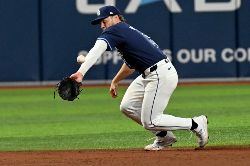 Jun 11, 2024; St. Petersburg, Florida, USA; Tampa Bay Rays shortstop Taylor Walls (6) misplays a ground ball in the sixth inning against the Chicago Cubs at Tropicana Field. Mandatory Credit: Jonathan Dyer-USA TODAY Sports