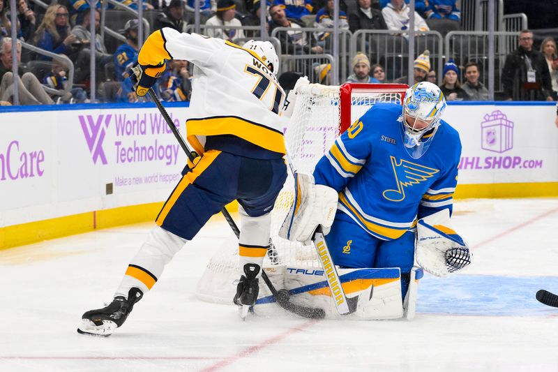 Dec 15, 2025; St. Louis, Missouri, USA; St. Louis Blues goaltender Joel Hofer (30) defends the net against Nashville Predators right wing Matthew Wood (71) during the third period at Enterprise Center. Mandatory Credit: Jeff Curry-Imagn Images