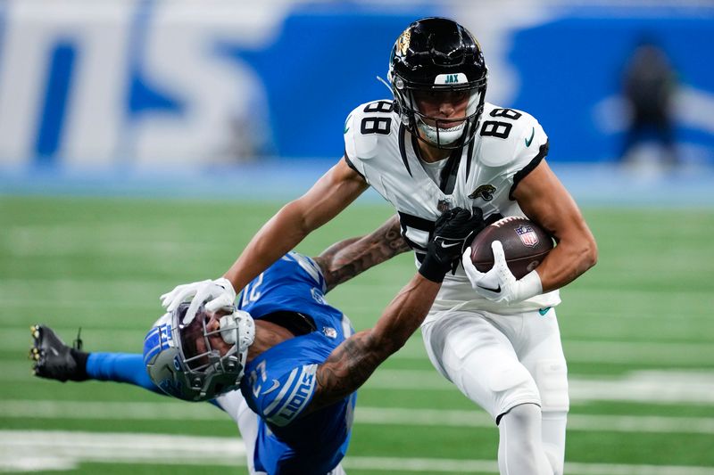 Jacksonville Jaguars wide receiver Oliver Martin (88) stiff arms Detroit Lions cornerback Chase Lucas (27) during an preseason NFL football game in Detroit, Saturday, Aug. 19, 2023. (AP Photo/Paul Sancya)