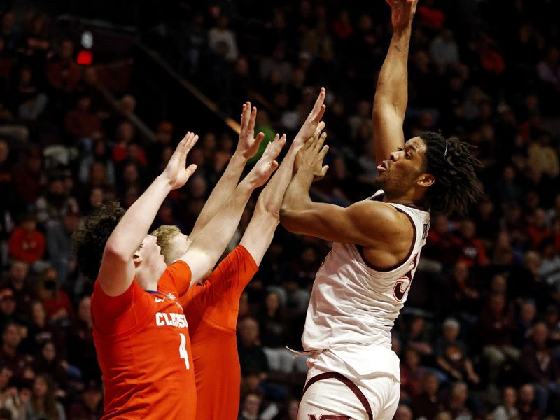 Jan 10, 2024; Blacksburg, Virginia, USA; Virginia Tech Hokies forward Mylyjael Poteat (34) shoots the ball against Clemson Tigers forward Ian Schieffelin (4) during the second half at Cassell Coliseum. Mandatory Credit: Peter Casey-USA TODAY Sports