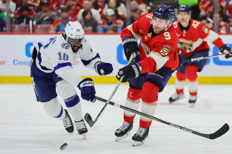 Apr 21, 2024; Sunrise, Florida, USA; Florida Panthers center Sam Bennett (9) moves the puck as Tampa Bay Lightning left wing Anthony Duclair (10) defends during the second period in game one of the first round of the 2024 Stanley Cup Playoffs at Amerant Bank Arena. Mandatory Credit: Sam Navarro-USA TODAY Sports