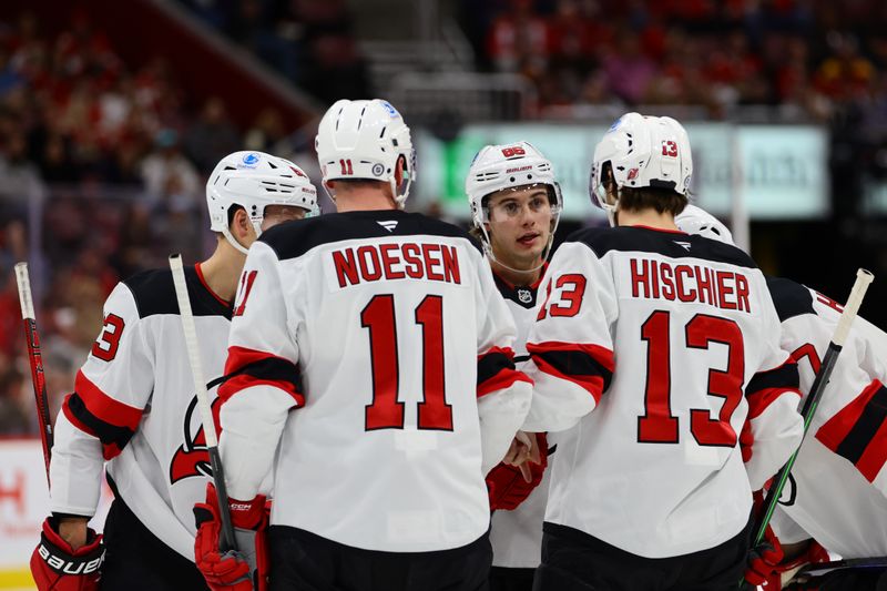 Nov 12, 2024; Sunrise, Florida, USA; New Jersey Devils center Jack Hughes (86) talks to right wing Stefan Noesen (11) and center Nico Hischier (13) against the Florida Panthers during the first period at Amerant Bank Arena. Mandatory Credit: Sam Navarro-Imagn Images